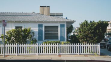 florida one level white house with white fence and blue shutters